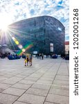 Small photo of Vienna, Austria - June 14, 2014: Sunrays above the Mumok museum. People moving between MQ social zones. Museumsquartier or MQ is a large area in the city of Vienna, Austria