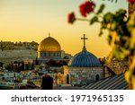The dome of a Christian church and the dome of the rock in the setting sun