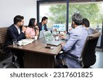 Indian business people meeting presentation in office conference room showing Charts Infographics on TV screen to show growth of company and big data analysis. E-Commerce e-Business.