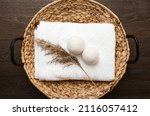 Small photo of Natural wool dryer balls for more soft clothes while tumble drying in washing machine concept. Earthly tones, reed decoration. Discharge static electricity and shorten drying time, save energy.