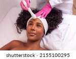 Small photo of woman applying plasma jet on her face