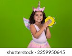 Small photo of adorable little girl wearing a unicorn costume holds a tambourine in her hands for carnival