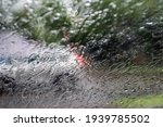 Blurred defocused image of a car driving through heavy torrential rain Rainfall flash flooding warning