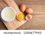 Closeup of raw chicken eggs in egg box on brown wooden background, organic food from nature good for health