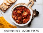 Small photo of Italian rabbit stew cooked with white wine, tomatoes and olives, thyme and rosemary. Coniglio all'ischitana. Ischia dish. Bread. op view.