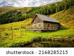 A lonely hut in the mountains. Mountain cabin. Mountain farm house. Lonely hut on mountainside