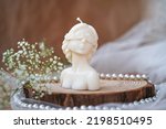 Decorative candle in form of woman bust. Soy candle handmade. Concept of femininity