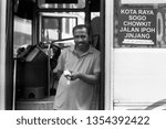 Small photo of Kuala Lumpur / Malaysia - March 2019: A photograph of a bus ticket collector in the heart of Kuala Lumpur taken in black and white film photography