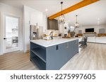 Small photo of Very large spacious kitchen with additional spice wok kitchen long white countertop with eating area dark grey service area with wine fridge glass cabinet shelving farmhouse sink