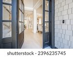 Small photo of Interior foyer entry front door with hat rack coat hooks decor wood and tile flooring open door vaulted ceiling exposed brick wall welcome to a warm and comfortable family home