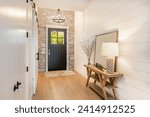 Small photo of Welcoming entry interior with large wooden and glass doors hardwood and tile floors staircase