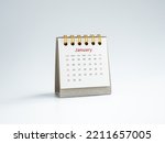 A January 2023 calendar desk for the organizer to plan and reminder isolated on white background, minimal style. White small table calendar with the page of the first month, Happy new year 2023.