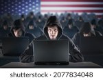Small photo of Many American hackers in troll farm. Security and cyber crime concept. USA flag in background.