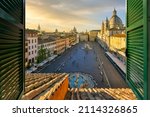 Small photo of Sunset view from a penthouse resort hotel room through a window with shutters of the famous Piazza Navona in Rome, Italy.