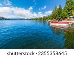 Small photo of Twin Lakes, Idaho USA - July 1 2023: Lakefront homes with docks and boat slips at lower Twin Lakes, an 850 acre lake in Twin Lakes, Idaho, a suburb of the general Coeur d'Alene area of North Idaho.