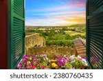 Small photo of Pals Spain - January 14 2023: Sunset view through an open window with shutters of the distant coastline and Catalonian countryside of the Costa Brava region from Pals, Spain, in the Girona Province.