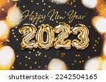 New year 2023 balloon celebration card. Gold foil helium balloon number 2023 and gold confetti stars isolated on black background. Flat lay, merry christmas, happy holidays congratulations.