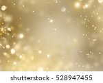 Christmas glowing Golden Background. Christmas lights. Gold Holiday New year Abstract Glitter Defocused Background With Blinking Stars and sparks. Blurred Bokeh.