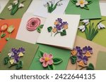 Small photo of quilling card with flowers. making greeting cards. Beautiful flowers designs. Paper quilling, colorful paper flowers. Hand made of paper quilling technique. Handicraft at home. Hobby, home office.
