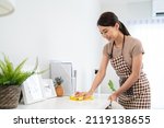 Small photo of Asian cleaning service woman worker cleaning in living room at home. Beautiful girl housewife housekeeper cleaner feel happy and wiping messy dirty working table for housekeeping housework or chores.