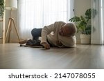 Small photo of Asian senior male falling on the ground while walk with walker at home. Elderly older mature grandfather having an accident after doing physical therapy alone after retirement in living room in house.
