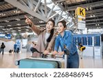 Small photo of Asian young women passenger walk in airport terminal to boarding gate. Attractive beautiful female tourist friends feeling happy and excited to go travel abroad by airplane for holiday vacation trip.