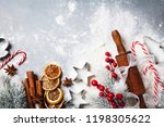 Bakery background for cooking christmas baking with rolling pin, scattered flour and spices decorated with fir tree top view.