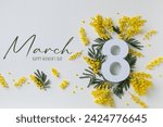 Small photo of 8 March celebration with number eight and text decorated with spring mimosa flowers top view. Happy Women Day white festive background.