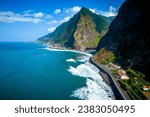 Small photo of Fantastic aerial view of the coast at Sao Vicente, Madeira, Portugal, where the mighty waves crash on the black beach, surrounded on high mountains