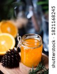 Small photo of Orange marmalade / orange jam in glass jar. A confiture is any fruit jam, marmalade, paste or fruit stewed in thick syrup. Orange marmalade & fruit jam in glass jar concept. Dark food photography.