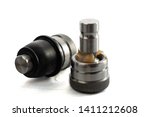 Small photo of tie rod end or ball joint on a white background on which the rubber cover is visually removed and lubrication visible, automotive part