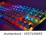 RGB gaming keyboard. Bright colorful keyboard, soft focus. Mechanical keyboard with RGB light, blurred background.