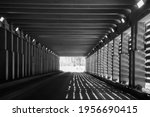black and white image of avalanche tunnels on the Trans Canada highway through Rogers Pass in  British Columbia shadows cast by sunlight transportation and roads background horizontal format 