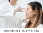 Small photo of plastic surgery, beauty, Surgeon or beautician touching woman face, surgical procedure that involve altering shape of nose, doctor injection to prepare for rhinoplasty, medical assistance, health