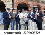 Small photo of YORK RACECOURSE, NTH YORKSHIRE, UK : 11 June 2022 : A group of young men on a Stag Day replicating Peaky Blinders by wearing flat caps whilst drinking at York Races