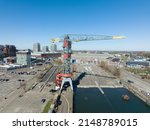 Small photo of Amsterdam, 19th of March 2022, The Netherlands. NDSM wharf crane modern industrial shipyard and trendy residential area. Amsterdam Noord along the Ij river and waterway.