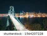 Classic panoramic view of scenic San Francisco skyline with famous Oakland Bay Bridge and traffic light trails illuminated in beautiful evening twilight at dusk in summer, SF Bay Area, California, USA