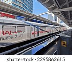 Small photo of BANGKOK, THAILAND - DECEMBER 7, 2019: Bangkok Skytrain (BTS) stops at the station. The advertisement from Prudential Life Insurance on the train says 'We are the doer.'
