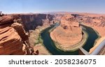Small photo of Horseshoe Bend is the name of the place where the Colorado River entrenched in the shape of a horseshoe near the town of Page, Arizona, United States.The boat floating on the river looks small.wide.