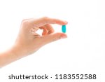 female hand holding a blue... | Shutterstock . vector #1183552588