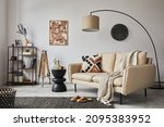 Stylish composition of elegant living room interior design with mock up poster frame, metal and wooden shelf, sofa, vintage vases and personal accessories. White wall. Copy space. Template.