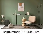 Stylish living room interior design with mock up poster frame, frotte armchair, wooden commode, side table, plants and creative home accessories. Sage green wall. Home staging. Template. Copy space.