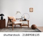 Minimalist composition of elegant living room space with white boucle armchair, photos mock up frames, carpet, coffee table, lamp, decoration and personal accessories. Copy space. Template. 