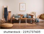 Sunny and bright space of living room with stylish sofa, pillows, coffee table, mock up poster frames, decorations, furnitures and personal accessories. Cozy home decor. Template. Summer vibe.	