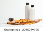 Small photo of Sesame seed and almond milk packaged in bottle for healthy drink from natural extract of unadulterated grains. Beverage served as treatment and provided essential vitamins for beauty skin care.