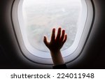 photo of child hand on a aeroplane vindow