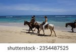 Small photo of Uvero Alto, Punta Cana, Dominican Republic, August, 29, 2023: excursion of tourists on horseback along a beautiful beach in Uvero Alto, Punta Cana, Dominican Republic