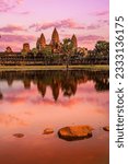 Small photo of Sunrise view of popular tourist attraction ancient temple complex Angkor Wat with reflection in Siem Reap lake, Cambodia