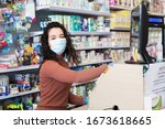 Small photo of Avetrana, Italy, - Marth, 13, 2020. Beautiful young cashier with medical mask and gloves working at the supermarket. Respecting health standards during Coronavirus, quarantine covid-19