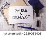 Small photo of Blackboard written pause reflect with alarm clock. Pause and reflect word with time on chalkboard background.